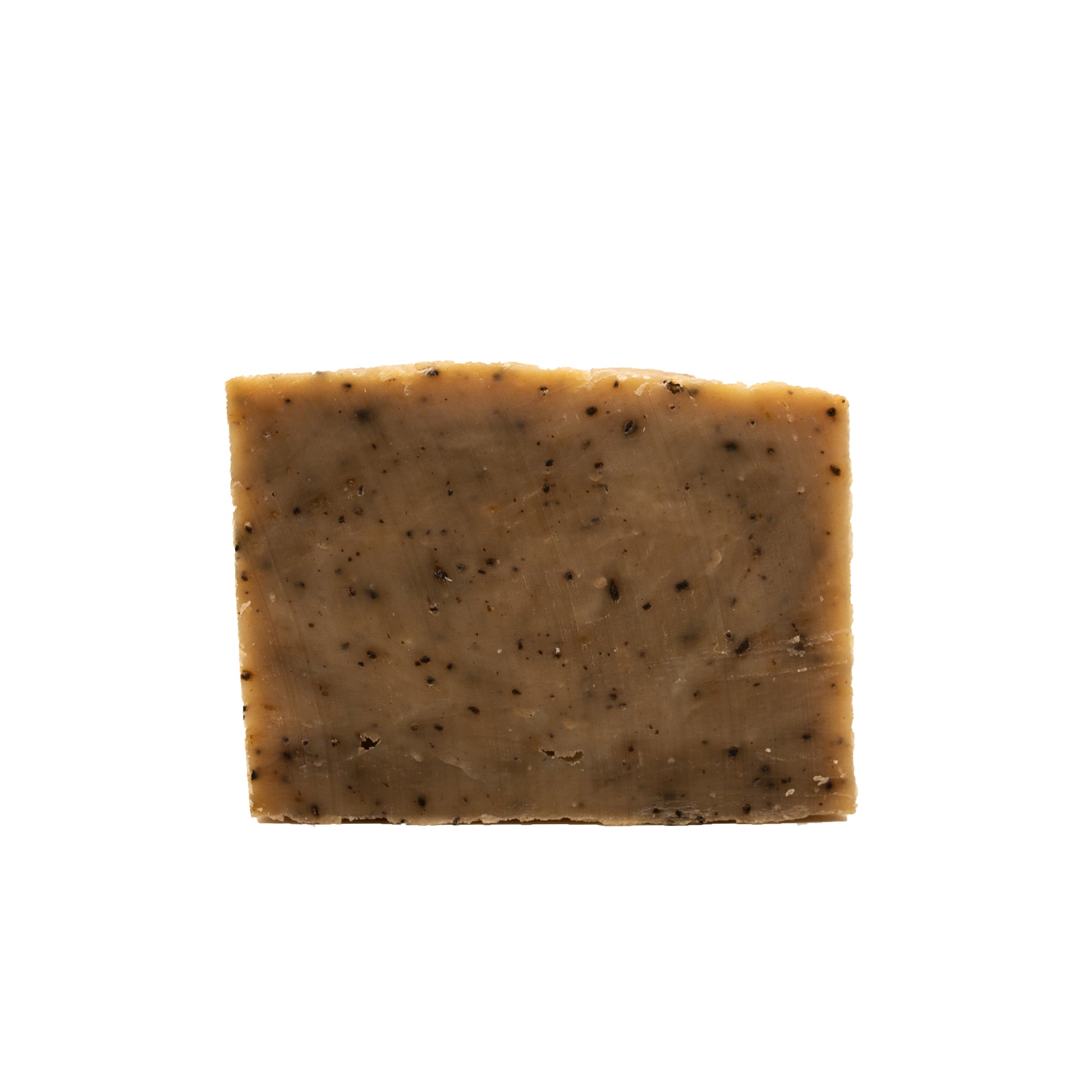 Brown soap bar with black coffee specks with a white background.